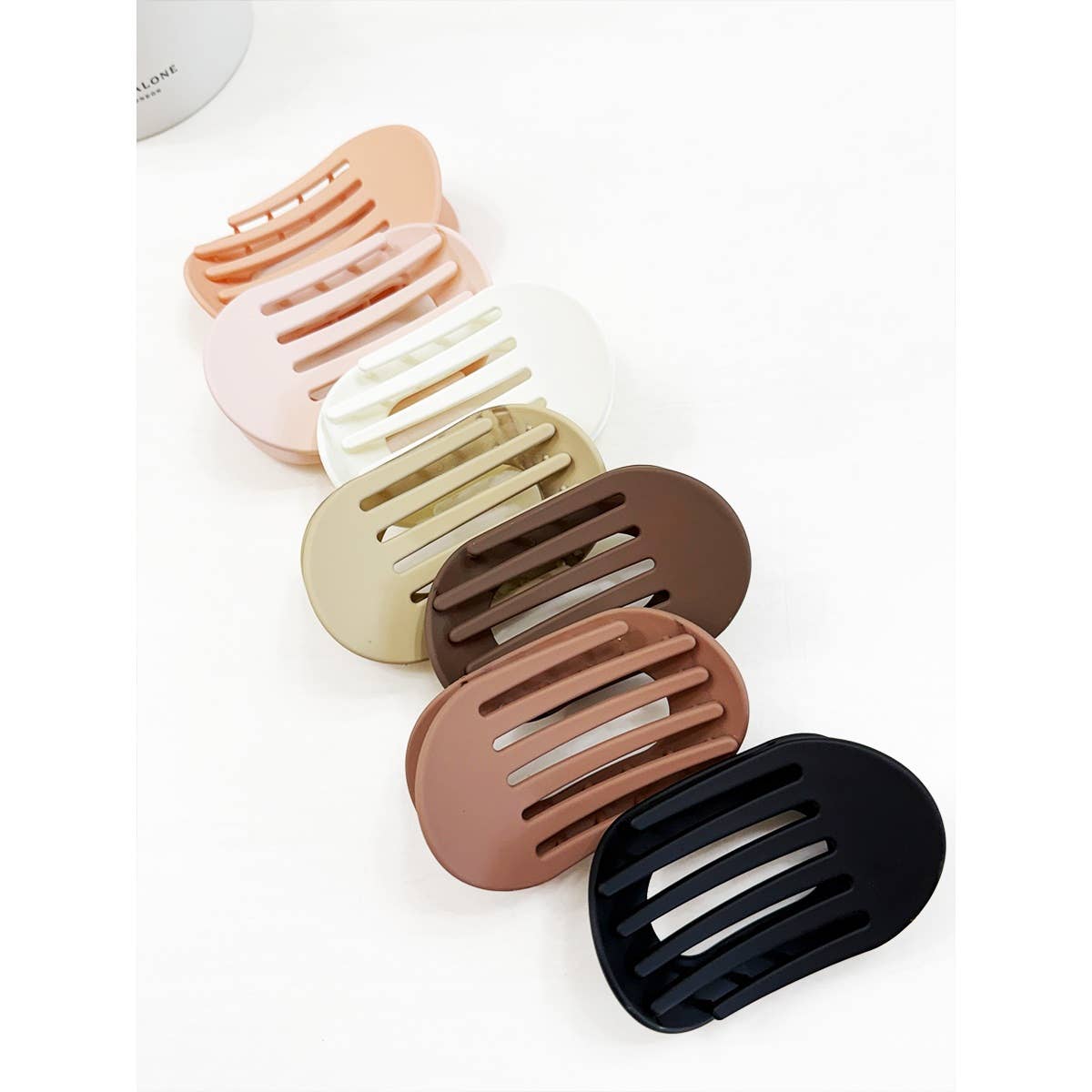 Set of five hair clips in different colors on a white background