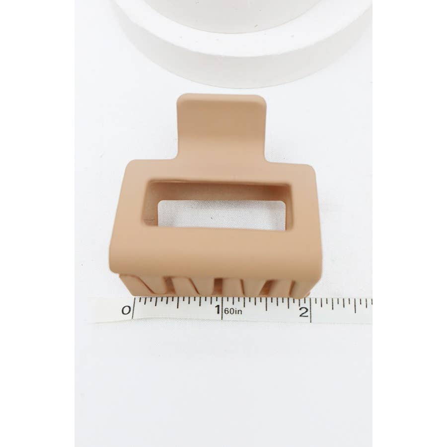 Beige soap dish with a rectangular soap compartment on a white background with a ruler for scale.