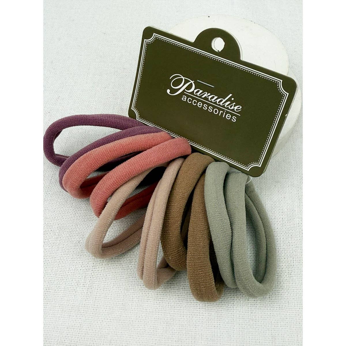 Set of colorful hair ties on a white background with 'Paradise Accessories' label.