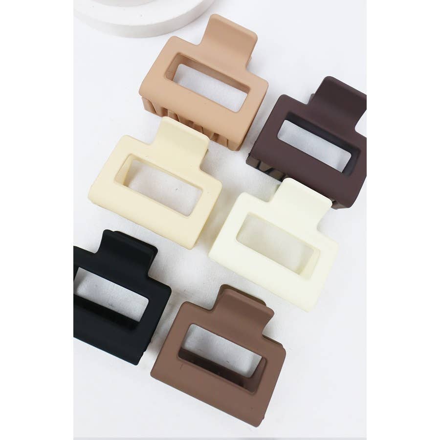 Set of six rectangular plastic clips in different colors on a white background