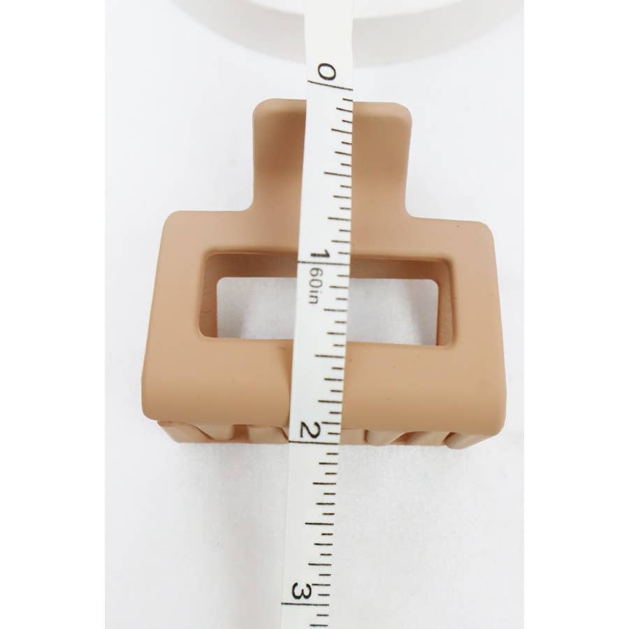 Beige square-shaped object with a tape measure on a white background