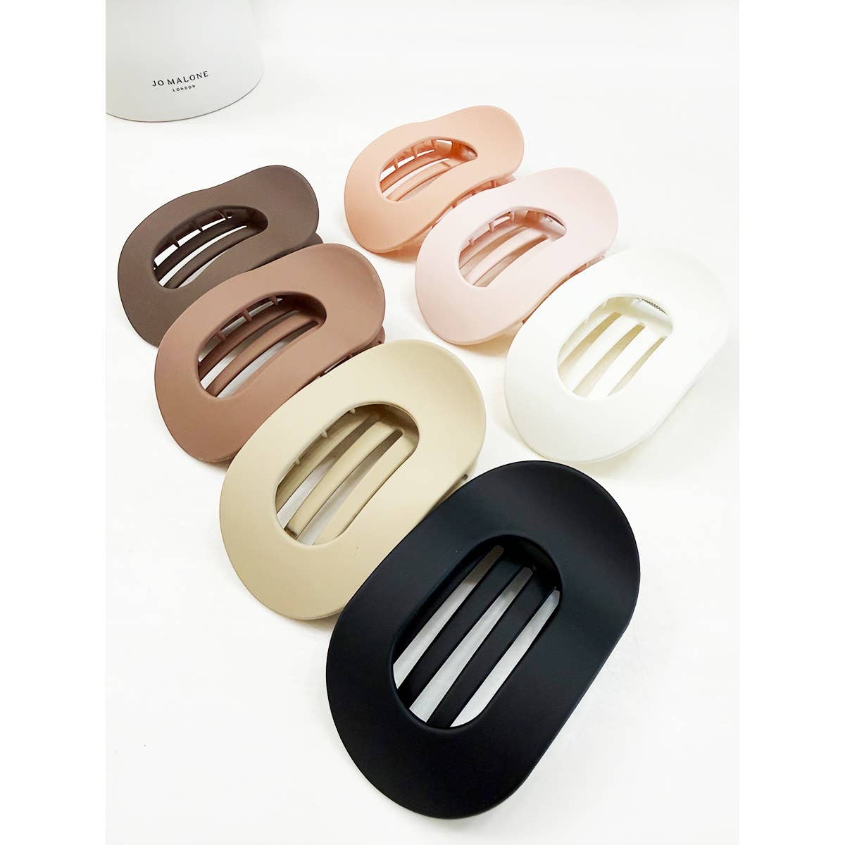 Set of six hair clips in various colors on a white background