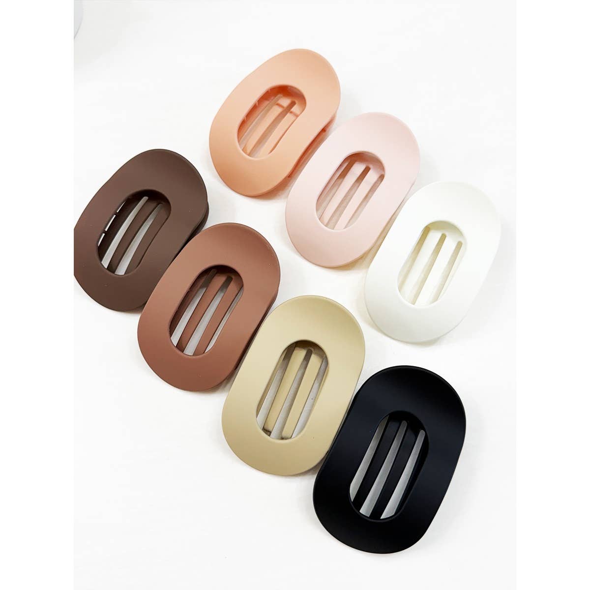 Set of oval-shaped hair clips in various colors on a white background