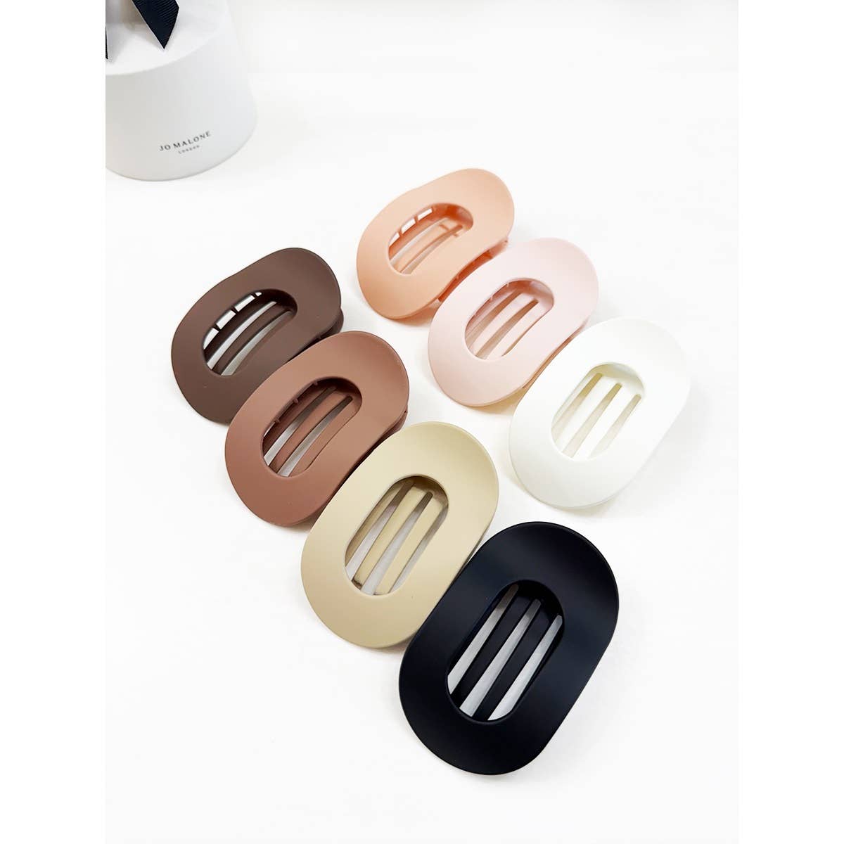Set of oval hair clips in various colors on a white background