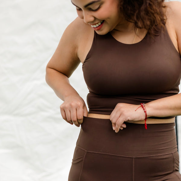 Woman wearing espresso colored athletic set.