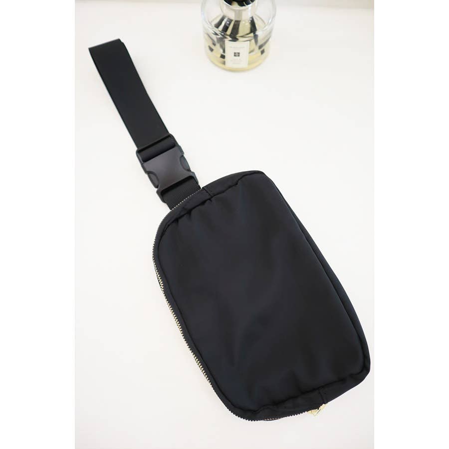 Black sling bag on a white background