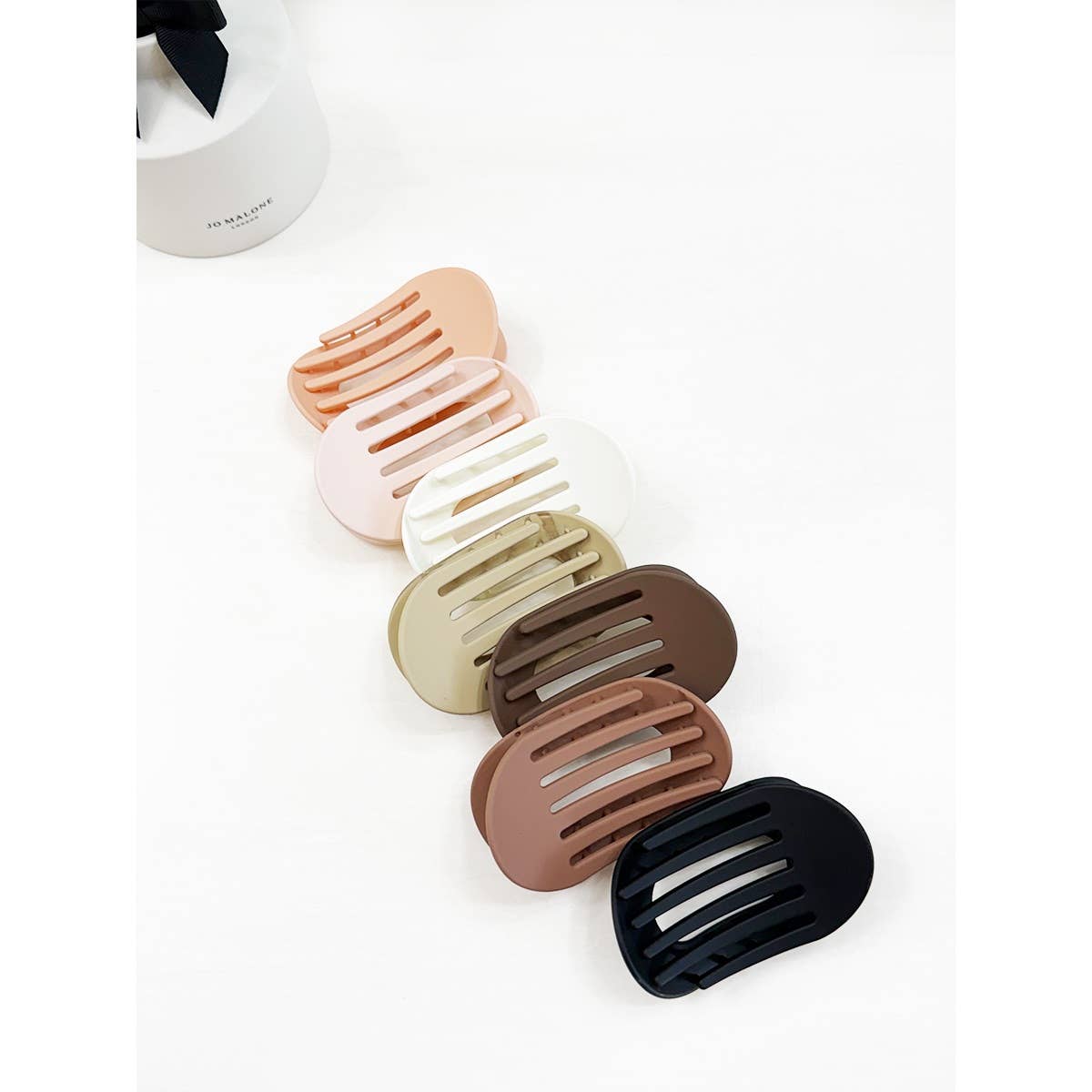 Set of five hair clips in various colors on a white background