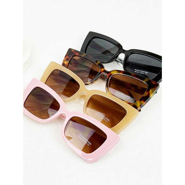 Four pairs of sunglasses in different colors on a white background