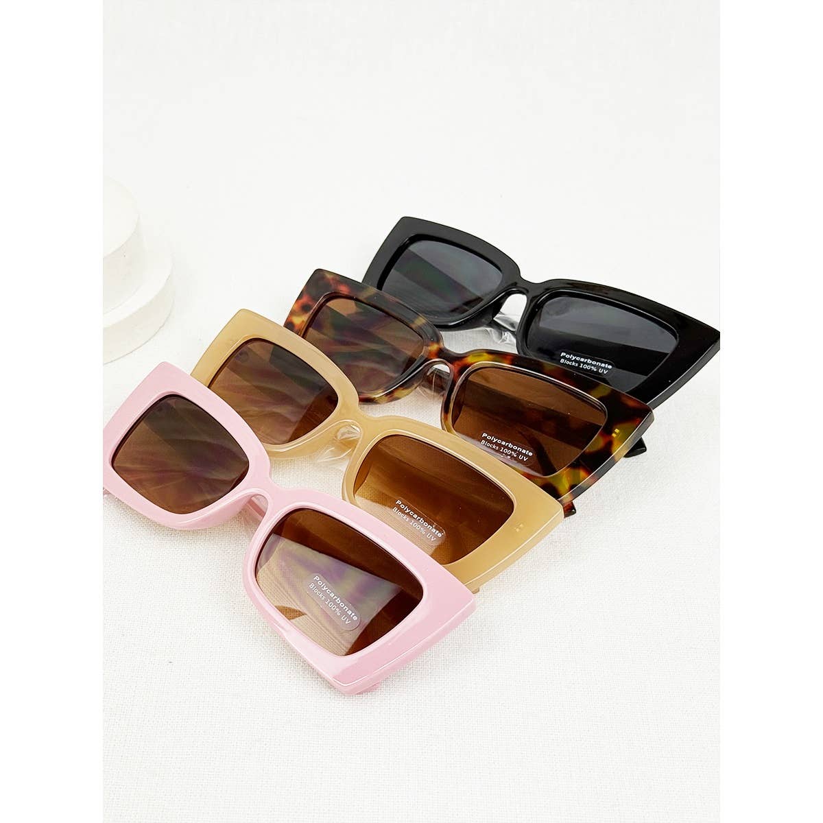 Set of sunglasses with different frame colors on a white background